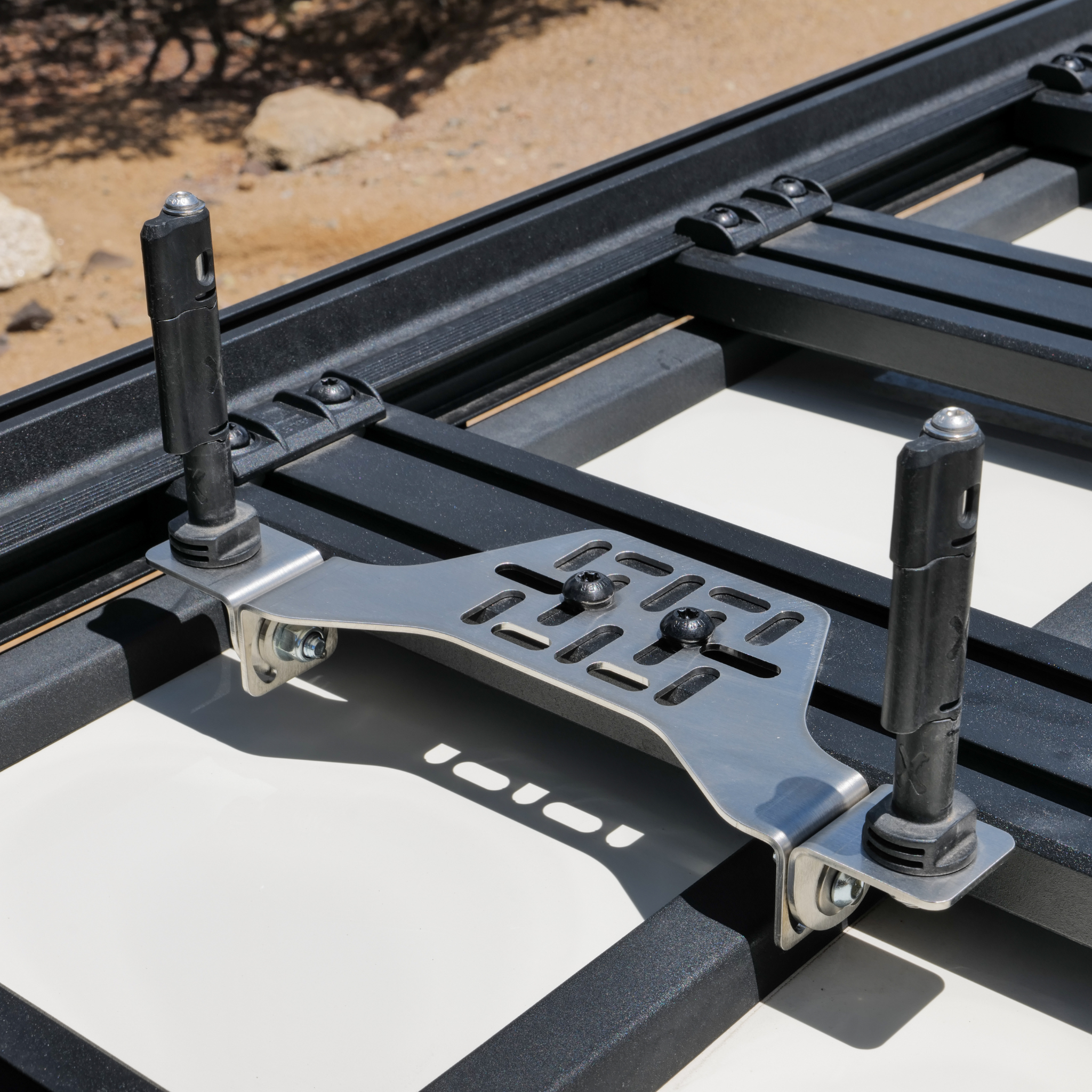 Stealth Folding Mount with Maxtrax Pins attached, Showing pins raised on a roof rack