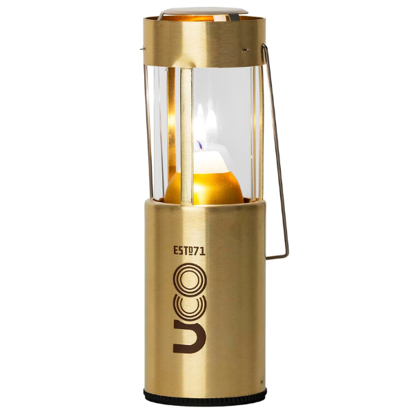 Woman lighting a UCO Candlelier candle lantern on an indoor table