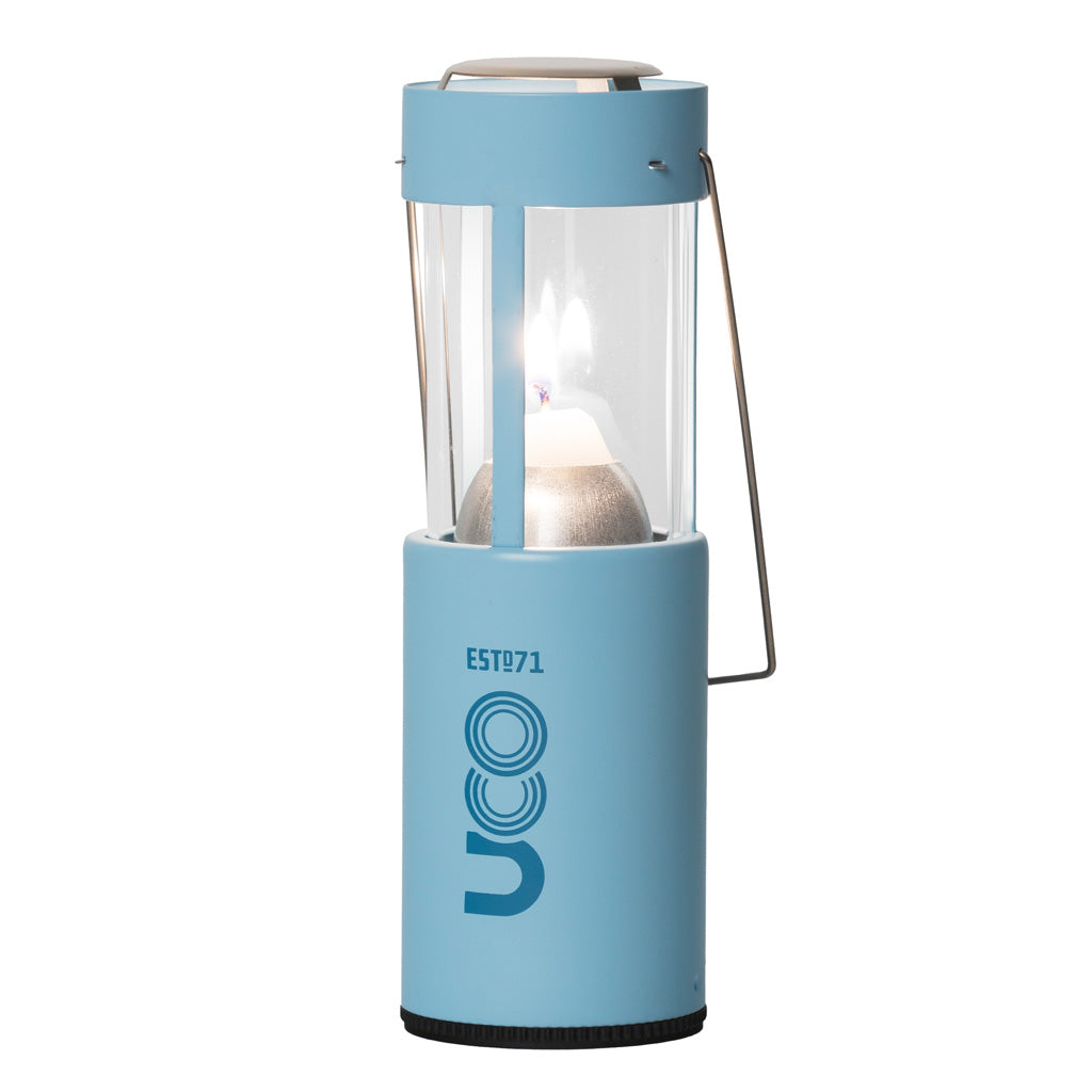 Ice blue UCO Candlelier candle lantern standing upright and lit