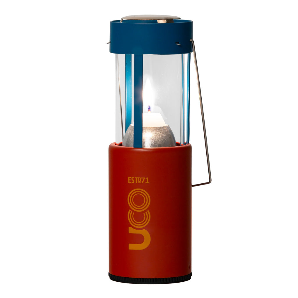 Navy blue UCO Candlelier candle lantern standing upright and lit