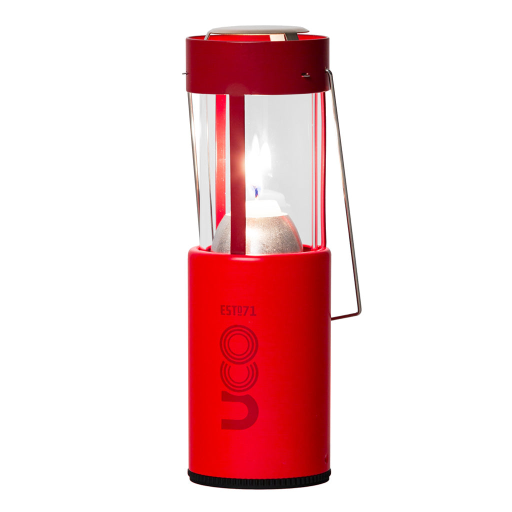 Red UCO Candlelier candle lantern standing upright and lit