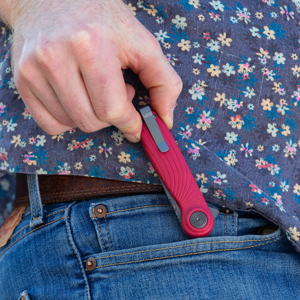 Red UCO Whidbey Mini folding knife clipped to a jeans pocket