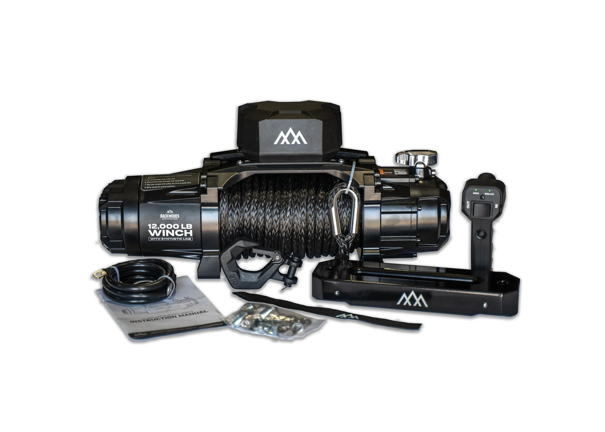 Backwoods 12,000lb winch with synthetic line, full kit flat lay showing the winch, wireless remote, hardware, and instruction manual