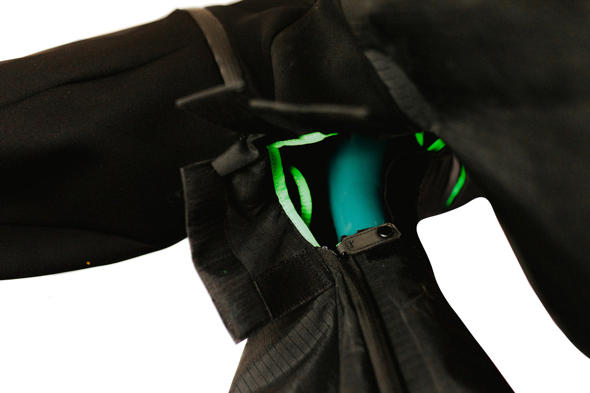 Green-trimmed zipper opening at the fork section of the cover showing the suspension fork inside
