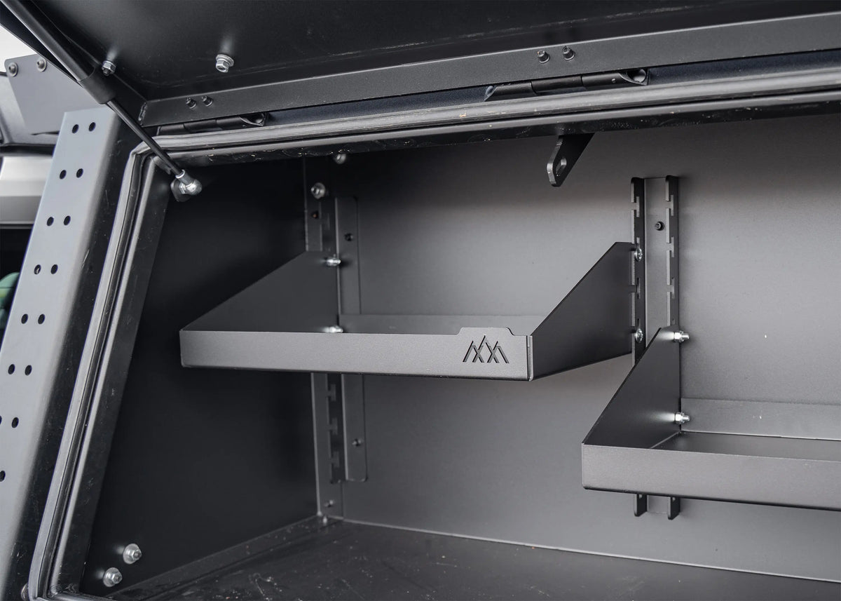 Adjustable shelf installed inside a Backwoods storage box, mounted on the bracket rails
