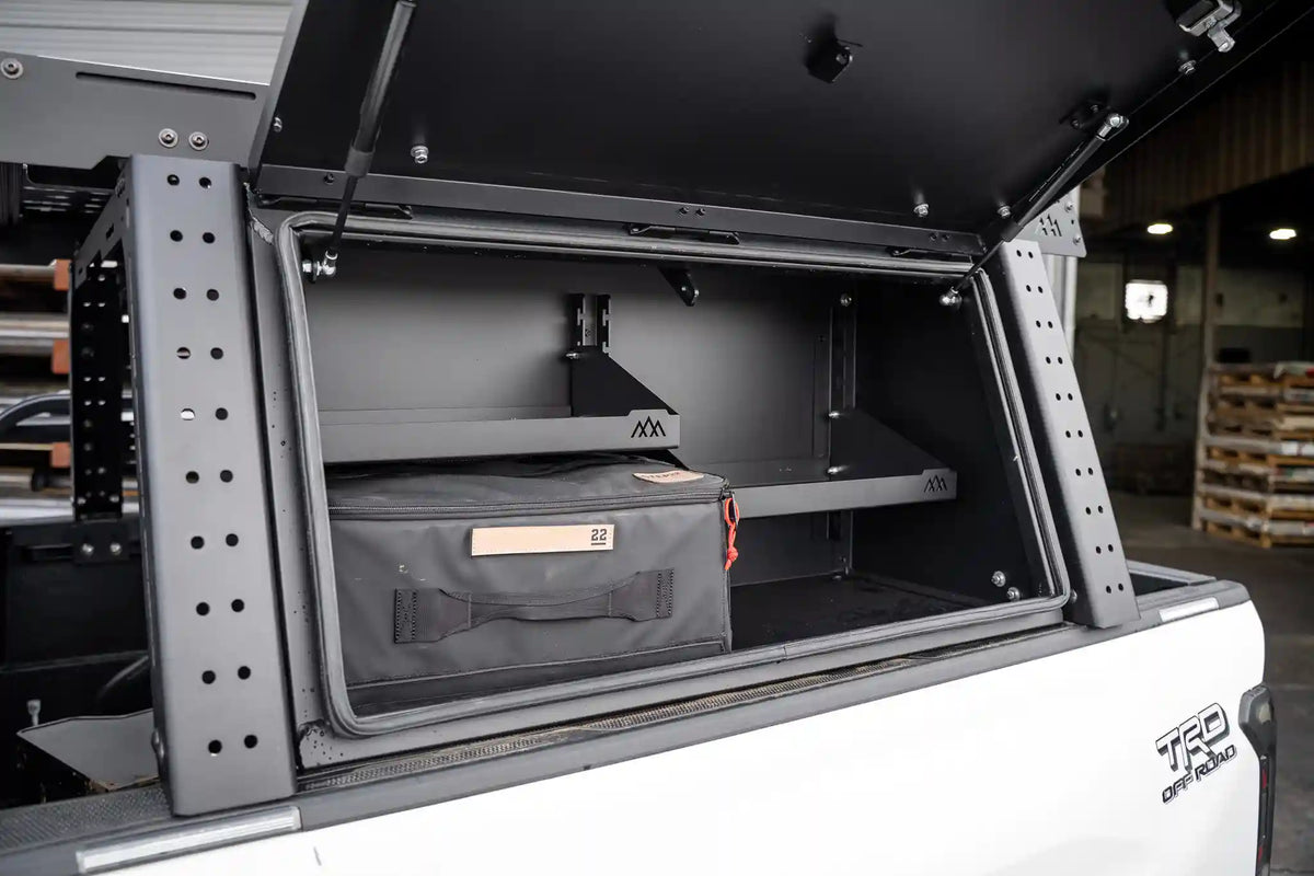 Bed rack storage box shelves in use, loaded with gear