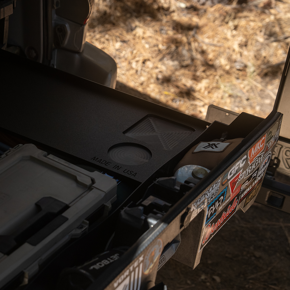 Grab n' Go cutting board sitting on a truck bed drawer system at camp