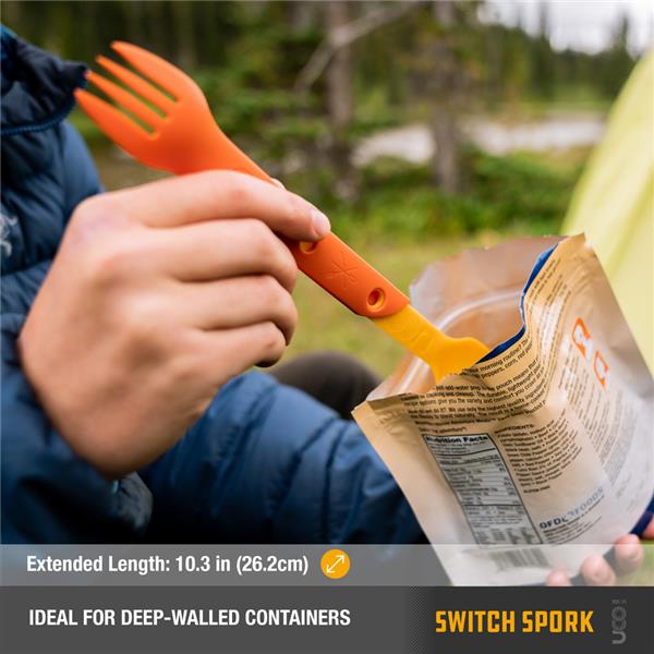 Hand using a teal UCO Switch Spork to eat from a foil food pouch