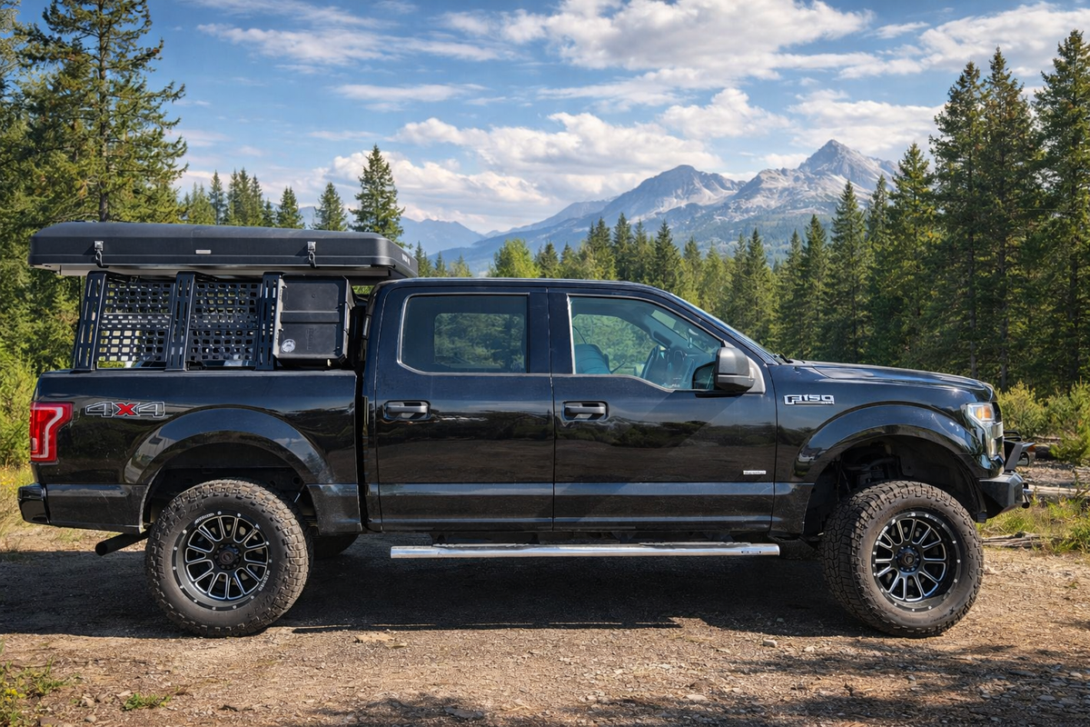 Black F-150 with low ROCK-IT rack and mountains behind