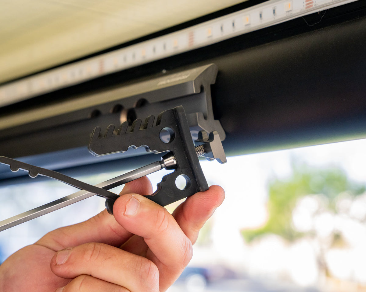 Adjusting a bracket on camper L-track with a screwdriver