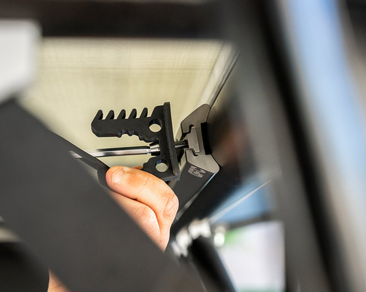 Close-up of a bracket bolted to L-track with a Freedom Coast nut