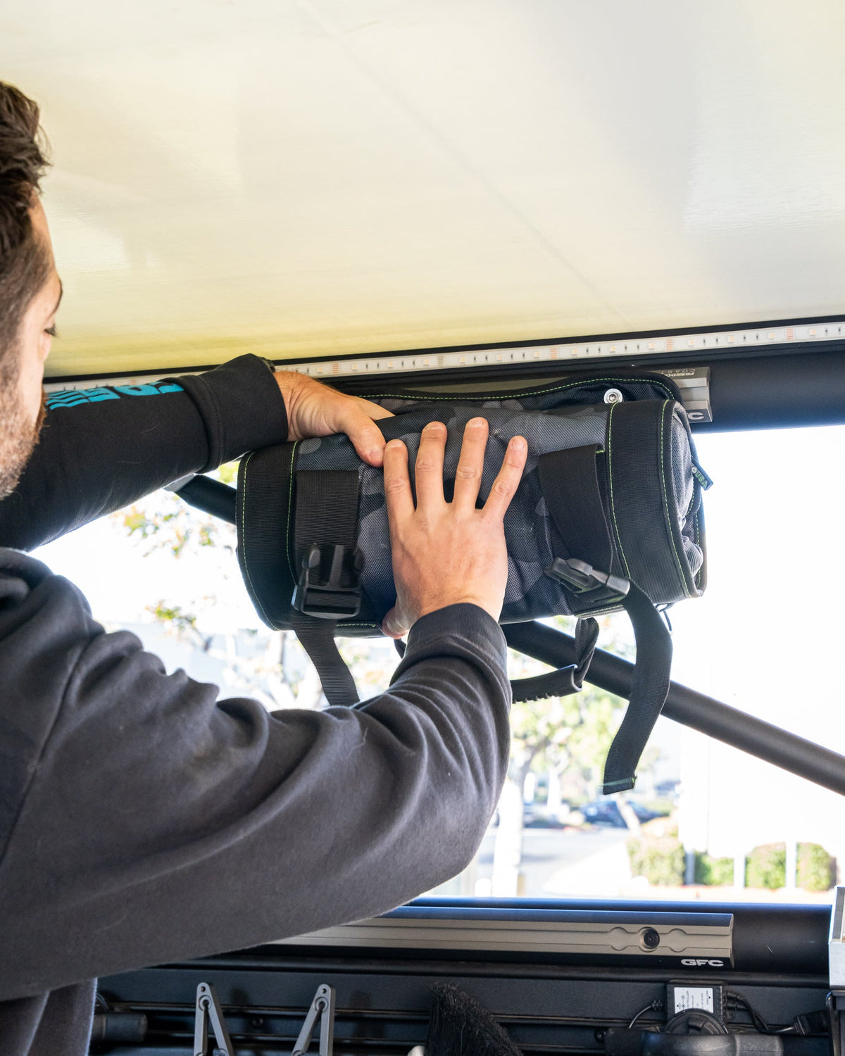Reaching into a camo organizer mounted on camper L-track