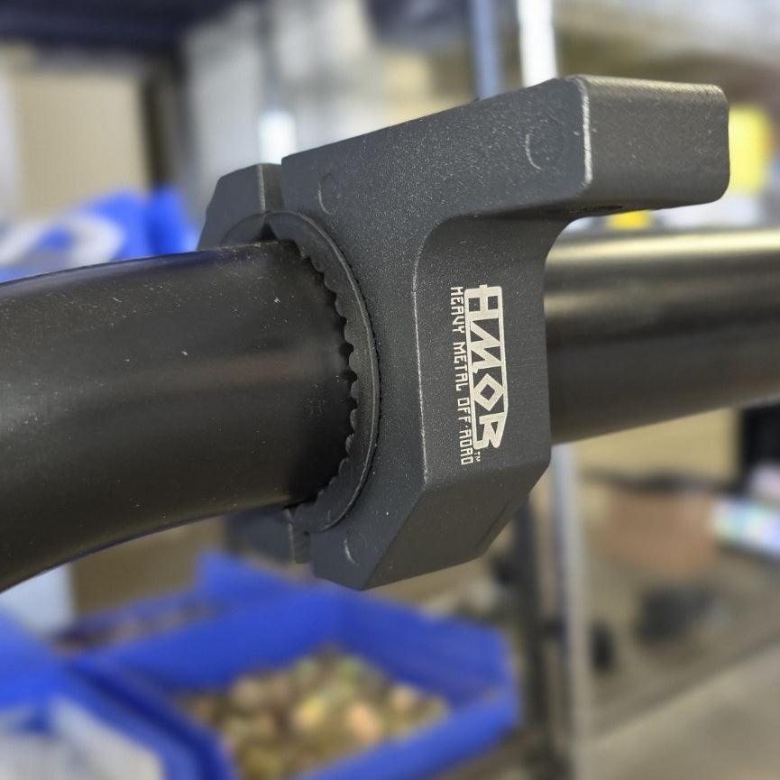 HMOR bolt-on tube mount clamped to a black round tube, side view with logo
