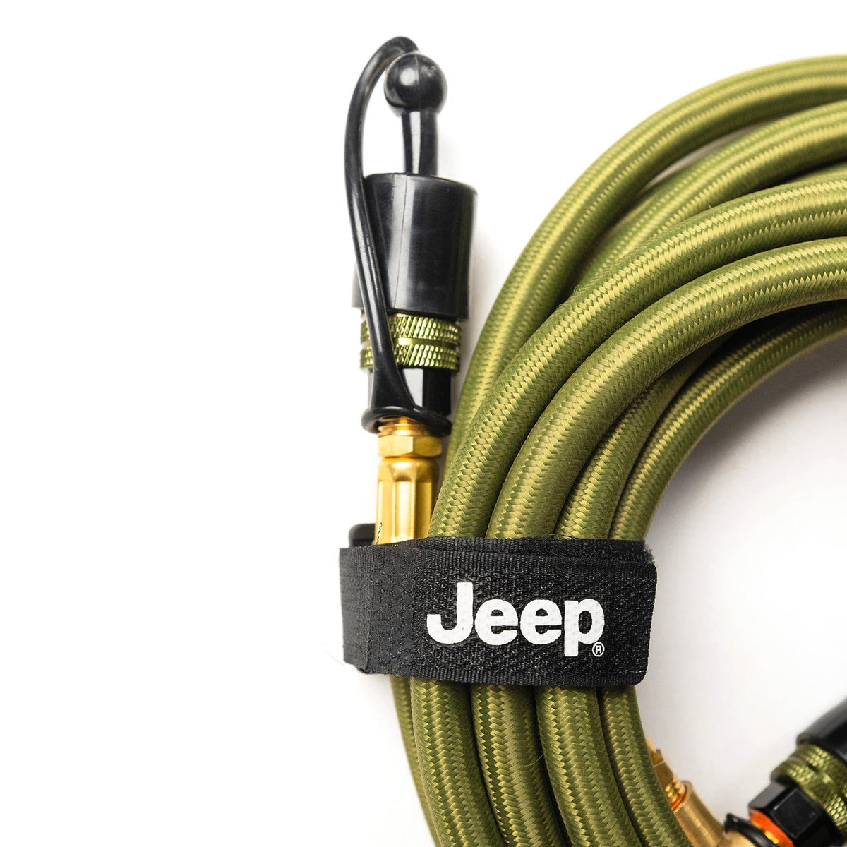 Close-up of a Rapid Multi-Tire Air System hose end with dust cap and olive braided sheath