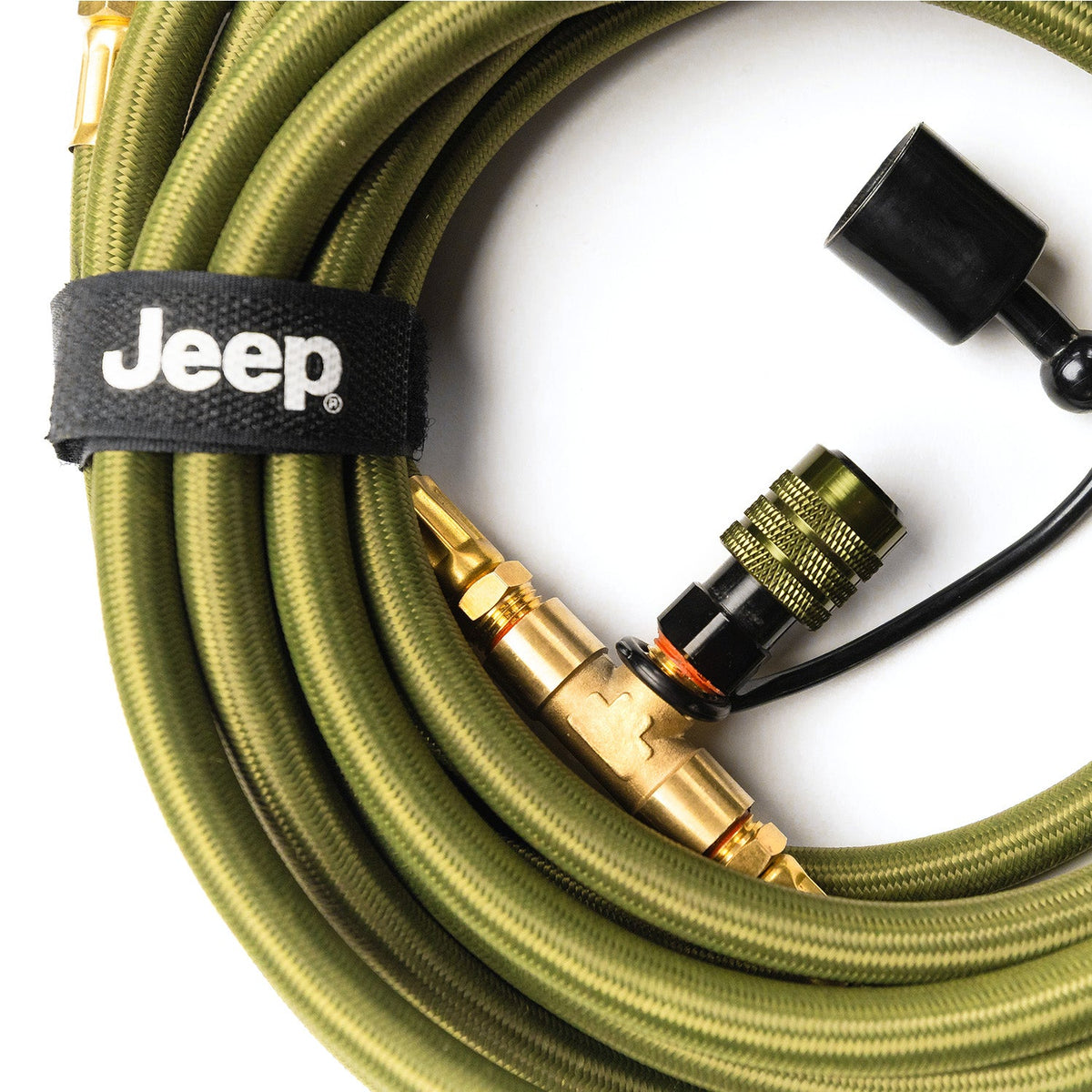 Close-up of a coiled hose's brass quick-connect fitting and Jeep-logo hook-and-loop strap