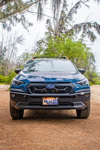 Front view of a blue Subaru SUV with a black brush bar