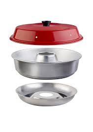 Omnia stovetop oven with red enamel domed lid, aluminum baking ring, and base tray shown stacked and exploded, studio shot