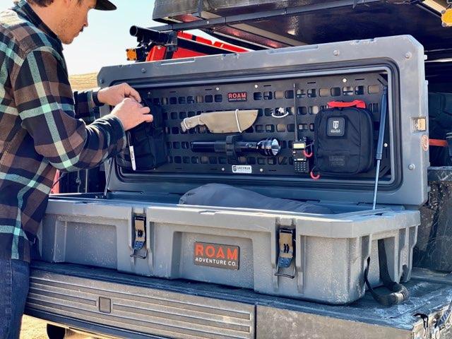 Close-up of the aluminum MOLLE grid on the ROAM 95L panel insert