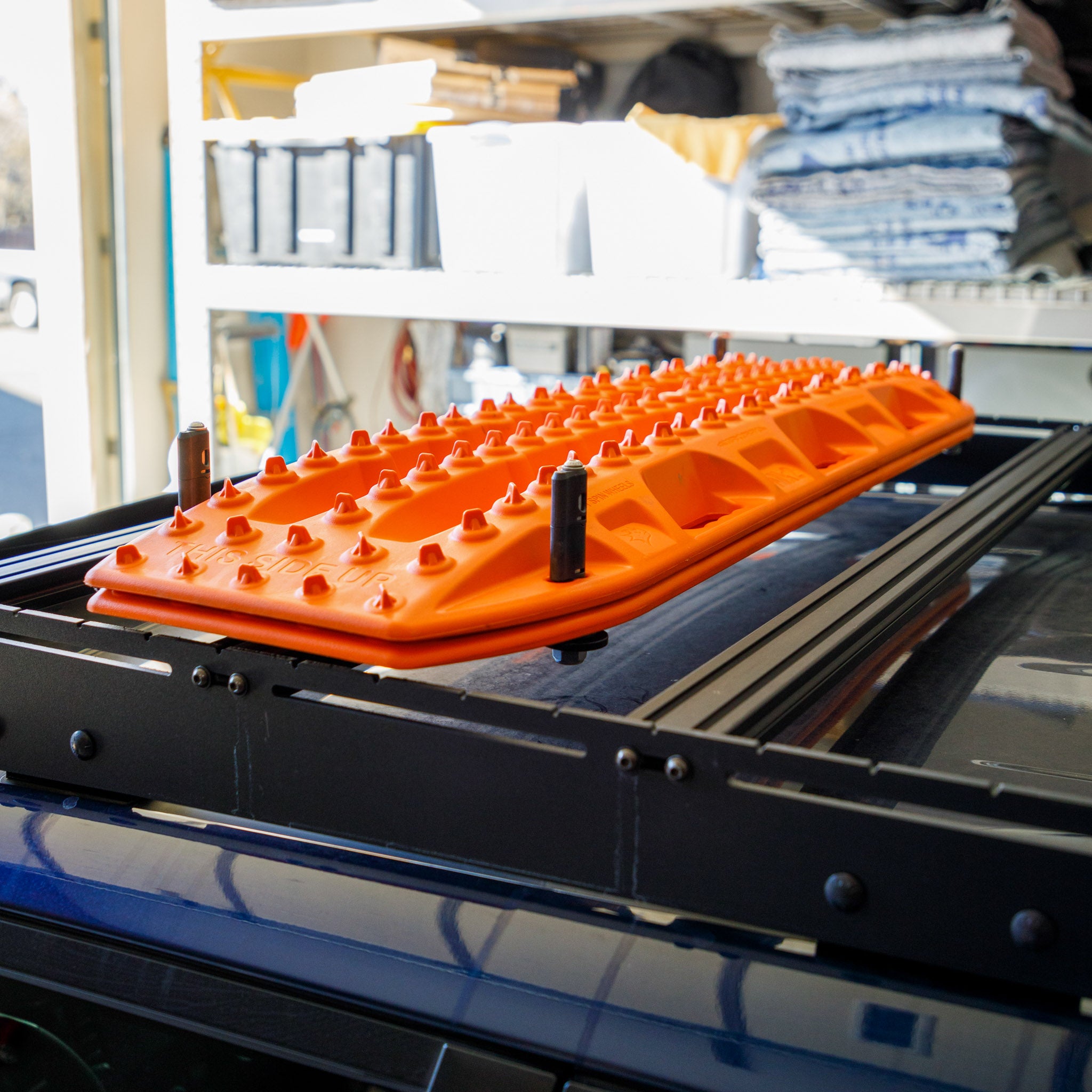 Overland Kitted Flat Roof Rack Mount For MAXTRAX - a finished install of the boomerang mount with orange Maxtrax on a Prinsu Roof Rack 