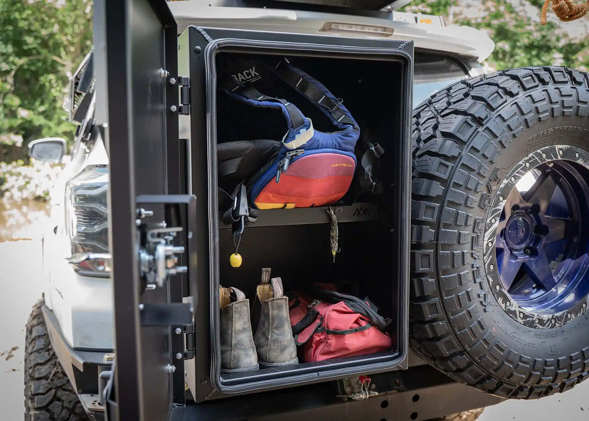 Overland storage box interior showing the adjustable shelves in use for gear storage