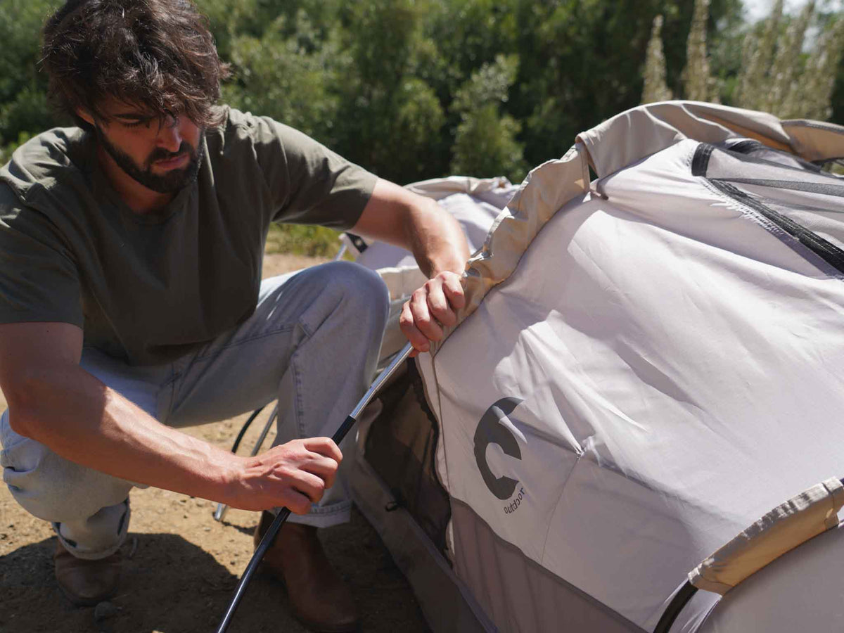 C6 Rev Rooftop Tent X (Element) – person setting up a tent pole