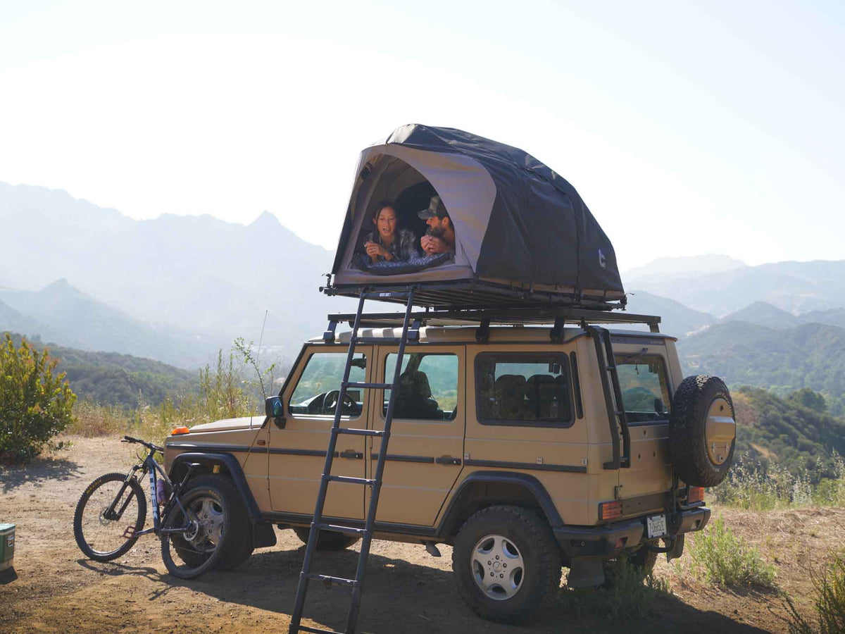 C6 Rev Rooftop Tent X (Eclipse) – on a vehicle roof at camp