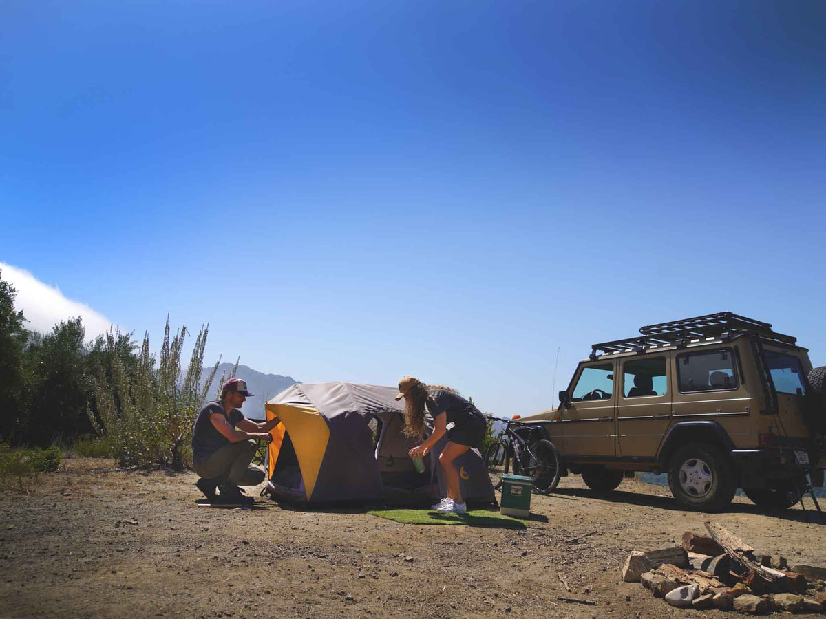 C6 Rev Tent (Element) – camp scene with the tent and a vehicle