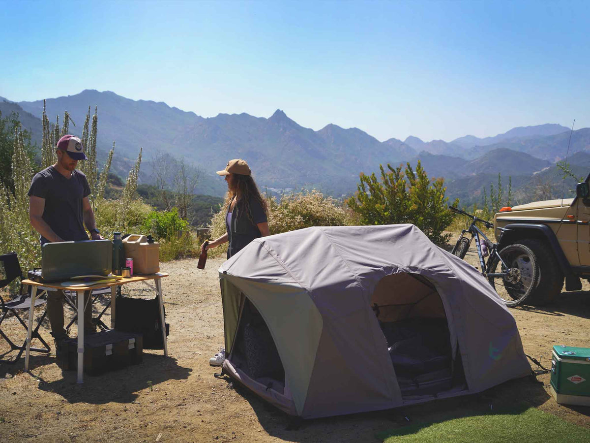 C6 Rev Tent (Element) – camp scene with the tent and a vehicle