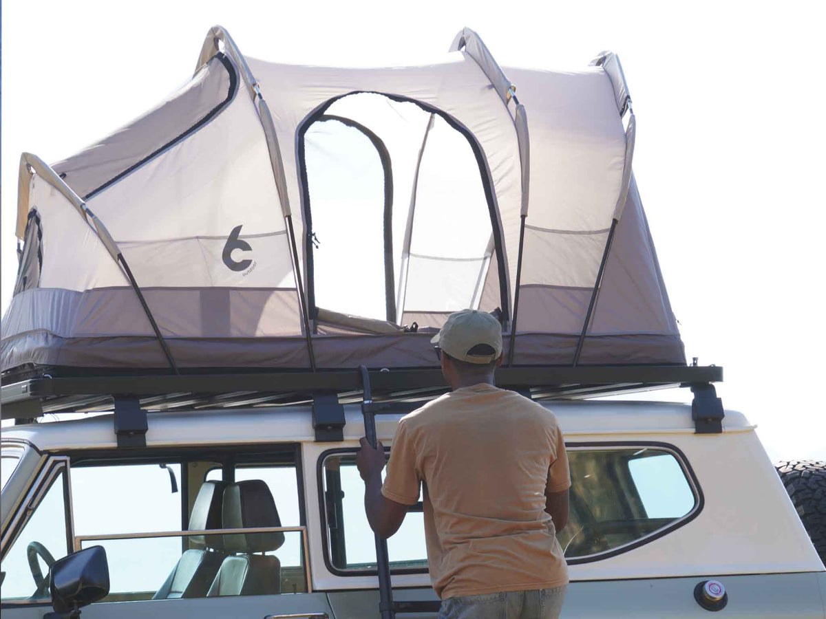 C6 Rev Rack Tent (Eclipse) – with fly sheet off, person at the tent on a vehicle roof