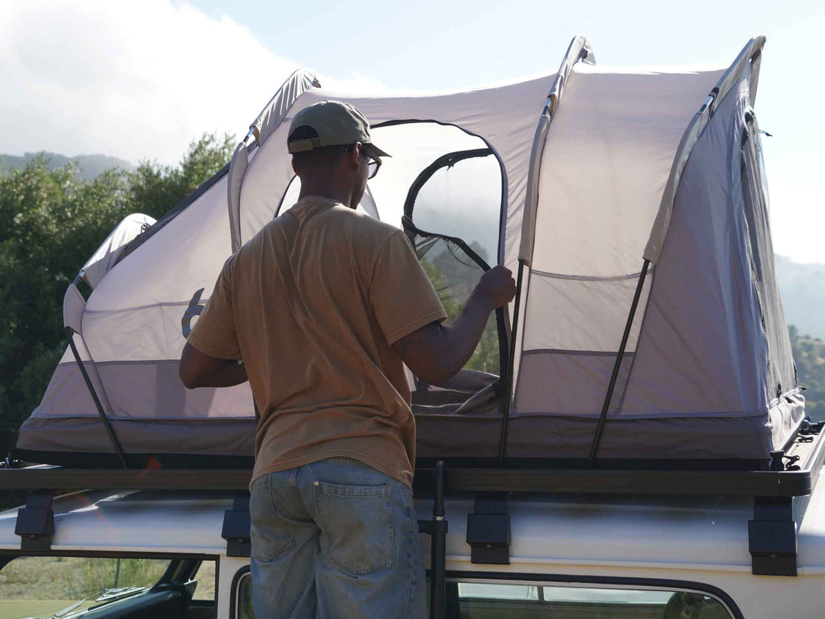 C6 Rev Rack Tent (HellaStorm) – with fly sheet off, person at the tent on a vehicle roof