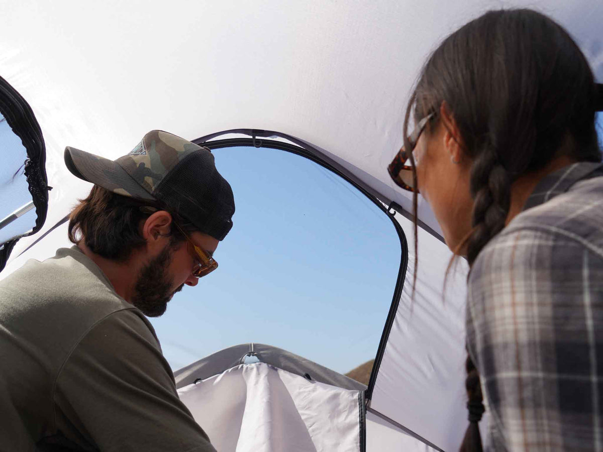 C6 Rev Rooftop Tent X (Eclipse) – two people looking at the roof window from inside