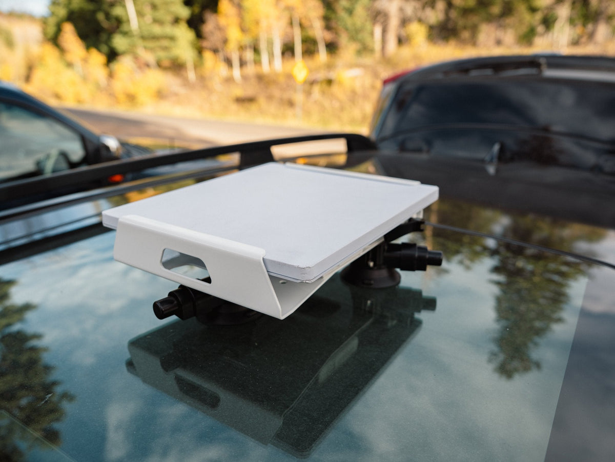 White Revolink mount on a glass sunroof, side angle