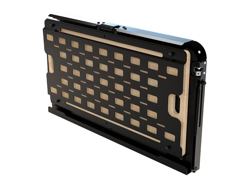 Closed Front Runner drop down tailgate table showing the black slotted Molle panel face with bamboo edge on a white background