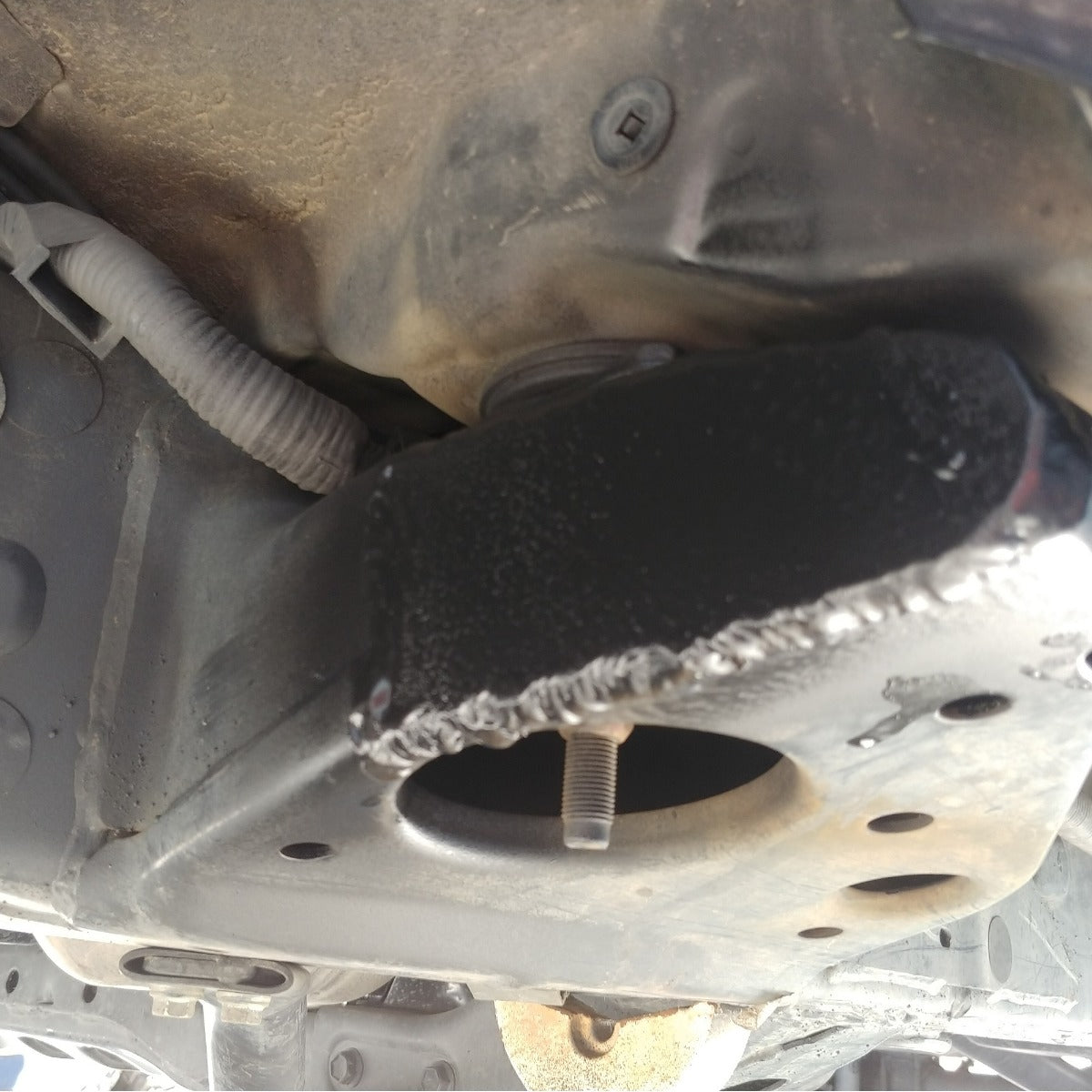 Underside view of chop plate welded in place