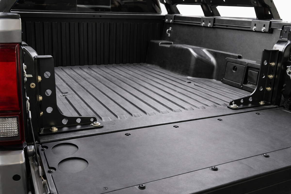 Pair of HMOR bed stiffener brackets installed in a 3rd gen Tacoma bed