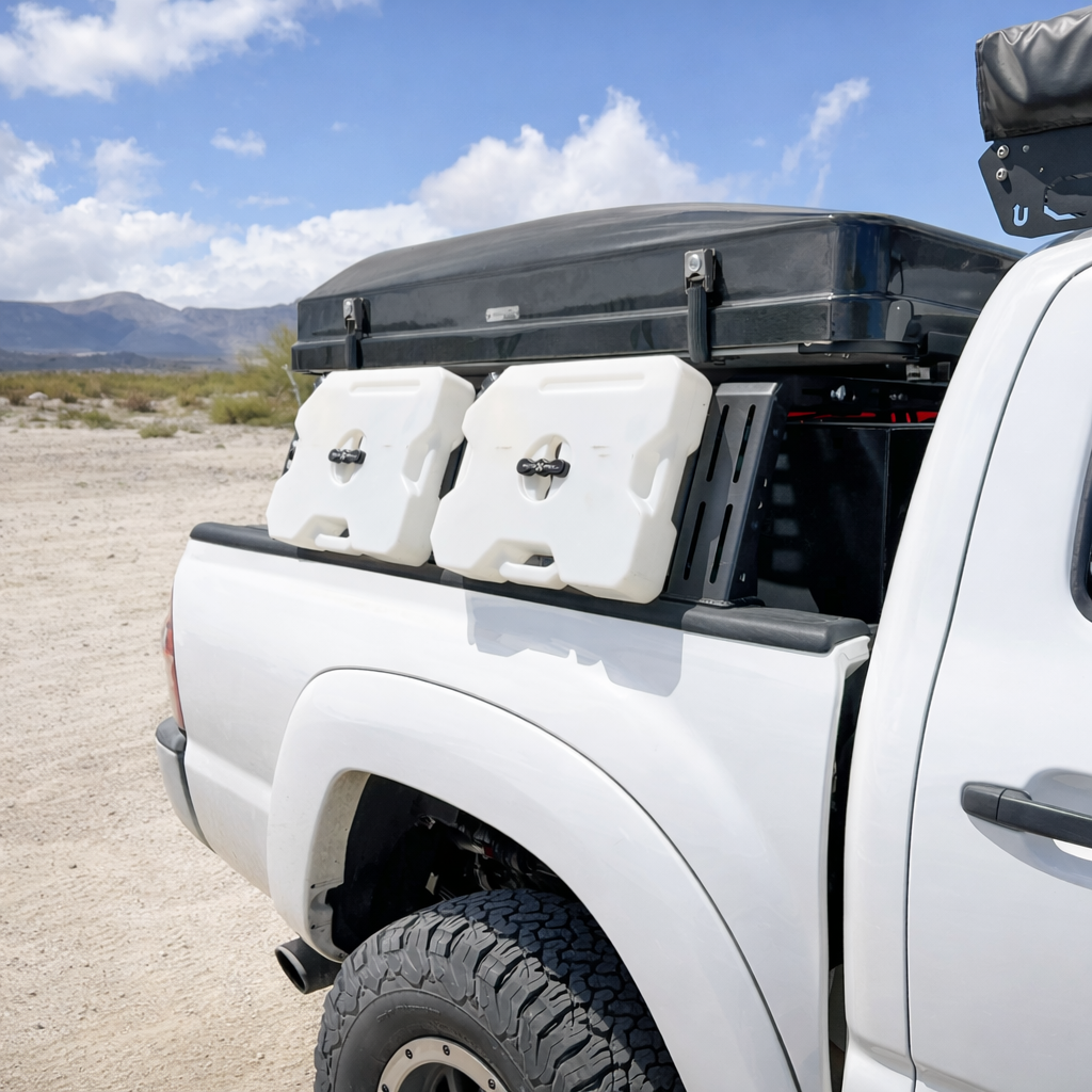 Water containers mounted to ROCK-IT MOLLE panels on a white Tacoma