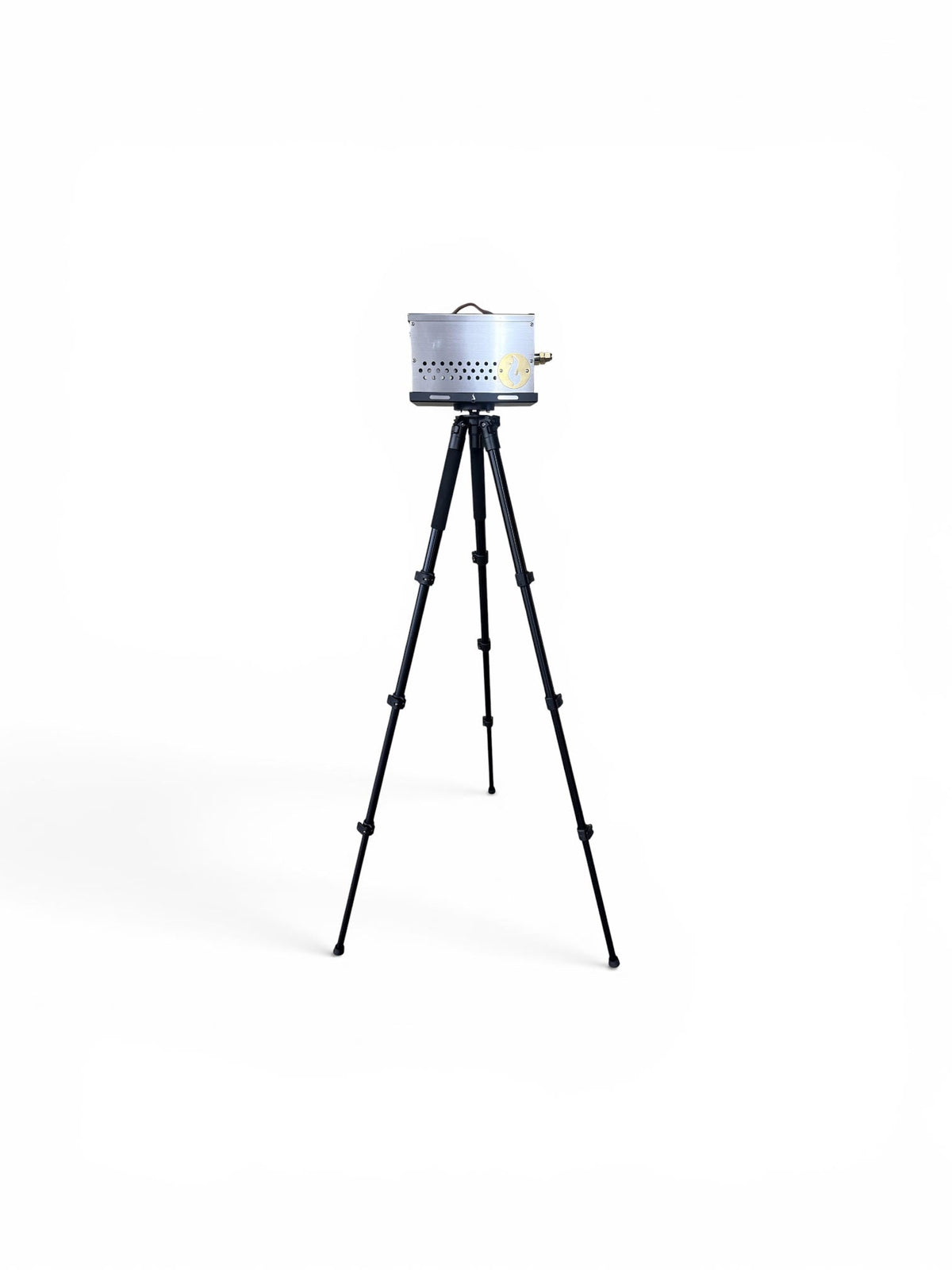 Stainless steel firebox mounted on the black tripod stand, studio shot on white background