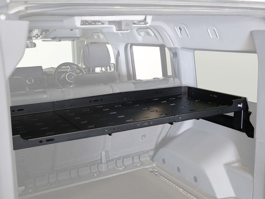 Side angle of the Front Runner interior shelf in an Ineos Grenadier, slotted deck extending over the load bay floor