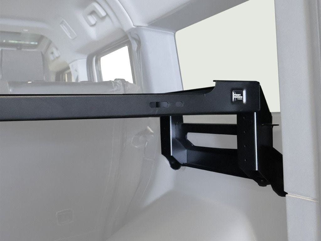 Side mounting bracket of the Front Runner interior shelf bolted to the load bay wall of an Ineos Grenadier