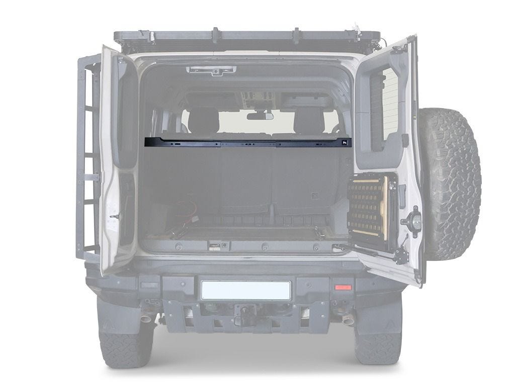 Rear view into an Ineos Grenadier load bay showing the Front Runner interior shelf spanning the width behind the rear seats