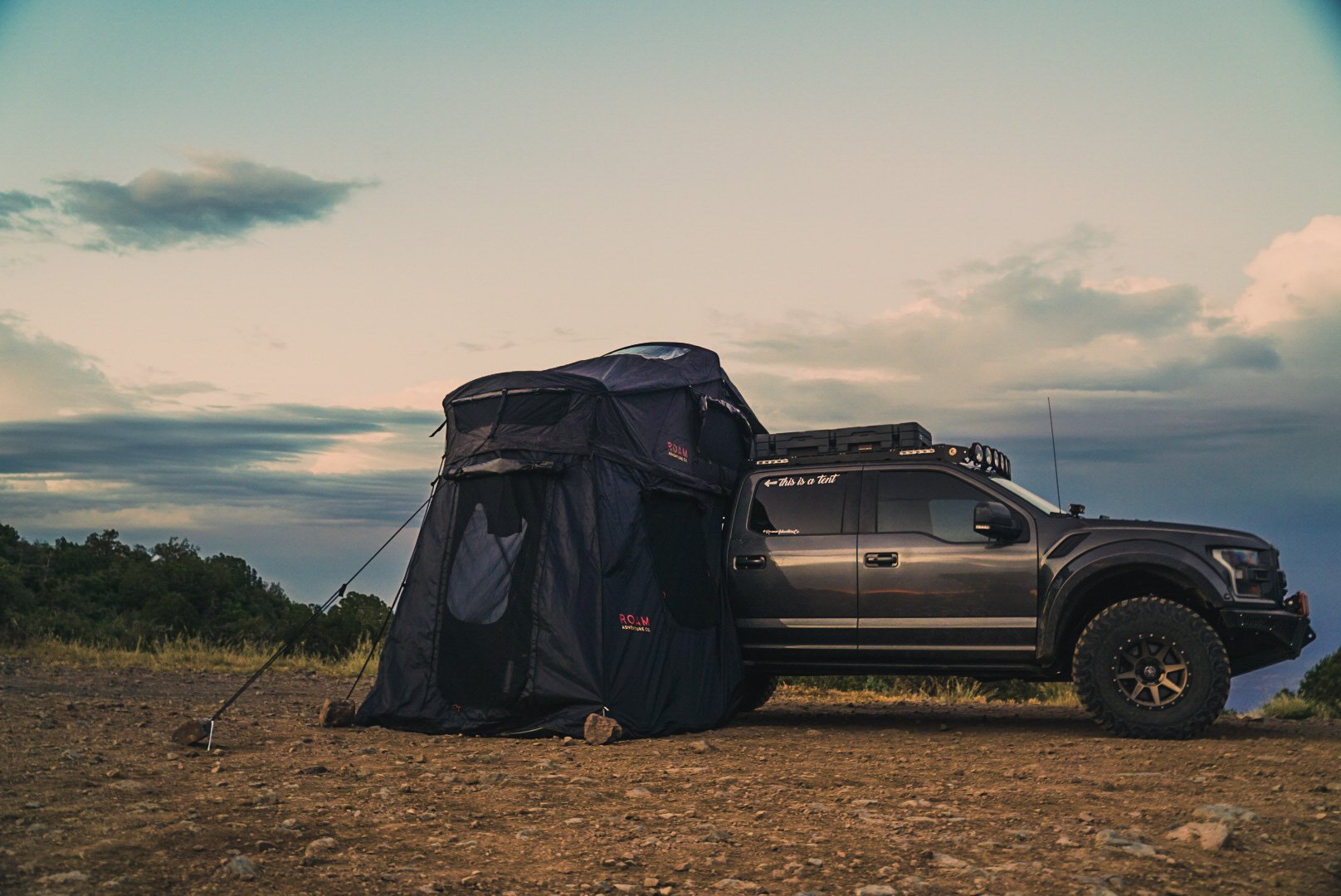 Black ROAM Vagabond rooftop tent with ground-level annex room set up